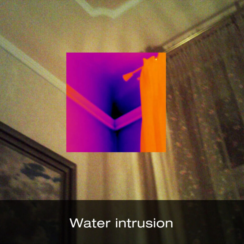 A digital image of the corner of a room where two walls and ceiling meet. At the point where these sides meet is a smaller thermal image showing water intrusion. The label at the bottom of the image reads "water intrusion".