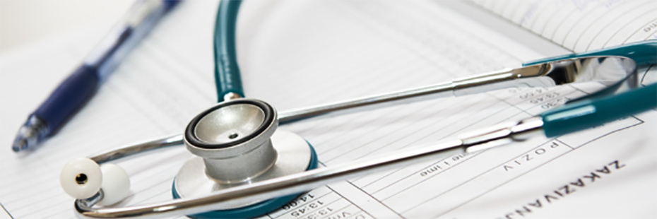 A stethoscope and blue ballpoint pen are lying on a diary/appointments page. 