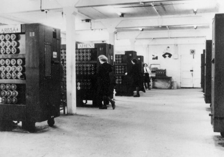 Black and white photo of WRENs operating Bombe Machines inside Bletchley Park Trust. 