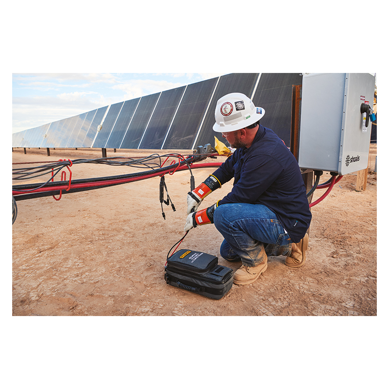 A man in a white hard hat is testing a PV/Solar Panel array using a PVA1500HE2.