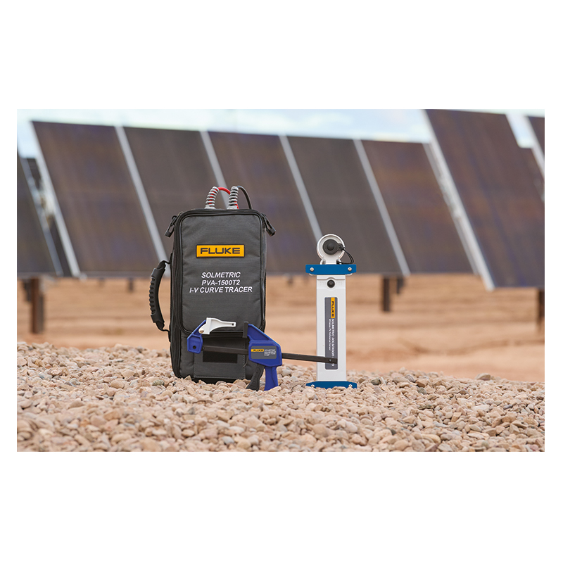 A PVA1500T2 with a SolSensor stands in gravel dessert in front of rows of solar panels 